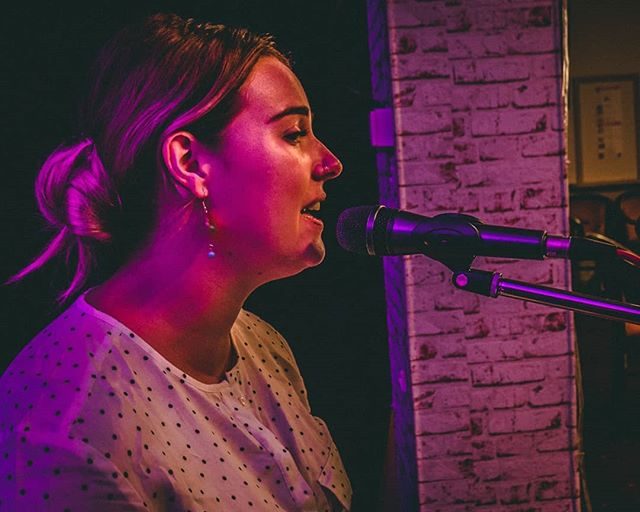 Adrianna Mac performing with guitar
